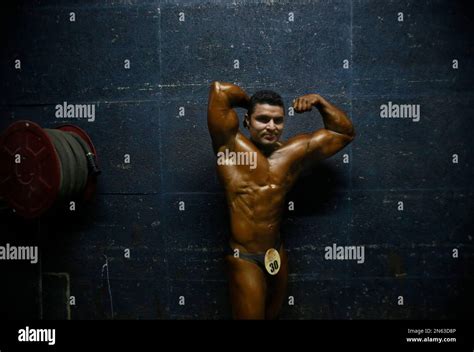 An Indian Body Builder Flexes His Muscles Before Going On Stage During