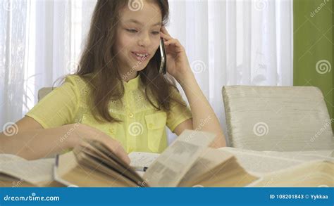 Teenager Girl Is Distracted By Telephone Conversation While Doing Her