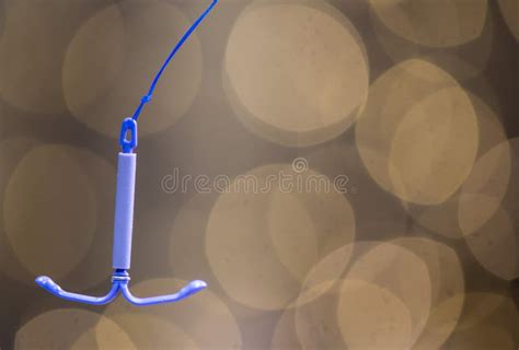 Holding an IUD Birth Control Copper Coil Device, Used for Contraception ...