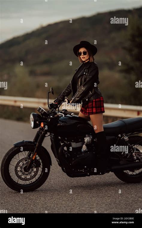 Stylish Motorcyclist Woman In Mini Skirt Leather Jacket Stands On