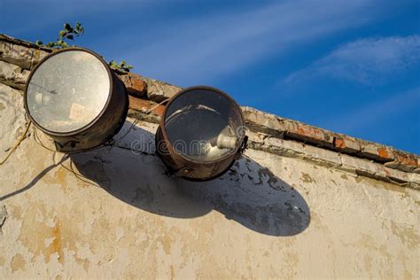 Two Spotlights On The Facade Of A Building In An Abandoned Factory