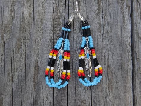 Native American beaded earrings. feather and seed beads.