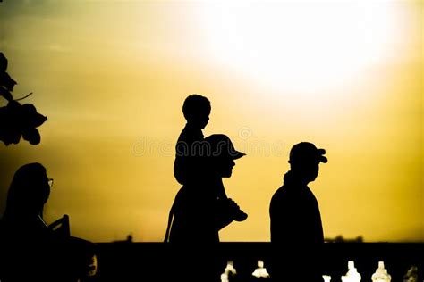 People Are Seen Walking And Having Fun At Sunset On The Porto Da Barra