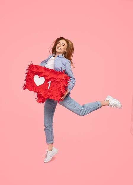 Premium Photo Cheerful Woman Jumping With Like Sign