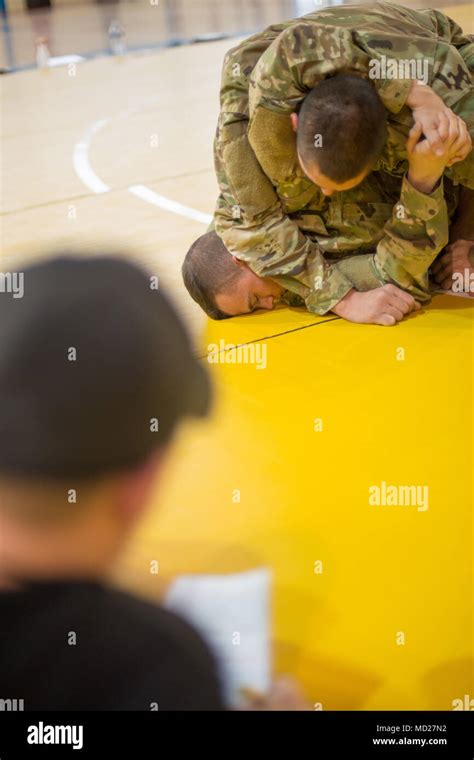 U S Army Sgt Christopher Nathan And Spc Jacob Ruth Grapple During A