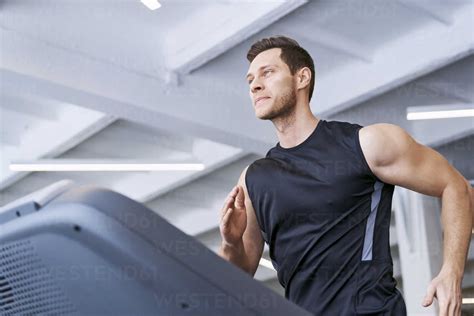 Man Running On Treadmill At Gym Stock Photo