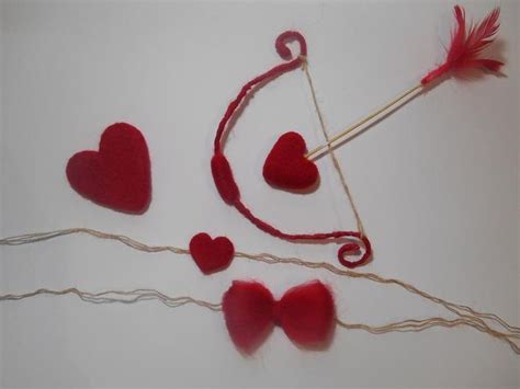 Some Red Hearts And An Arrow On A White Table With String Scissors And