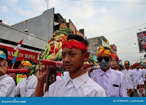 Balinese Men In Traditional Dress Bringing Offerings To Hindu Temple