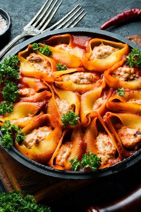 A Skillet Filled With Pasta Shells And Sauce