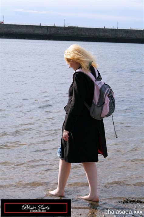 Solo Blonde Hottie Washing Her Feet In A River Photos