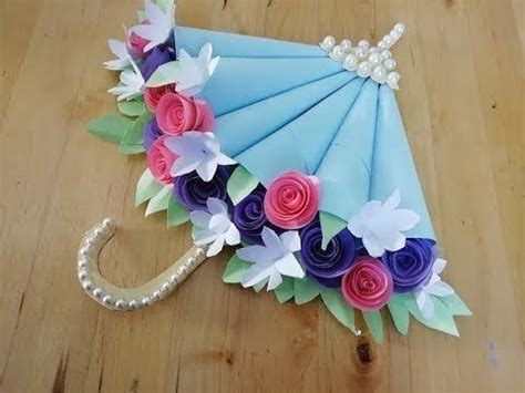 An Umbrella Decorated With Flowers And Pearls On A Wooden Floor In