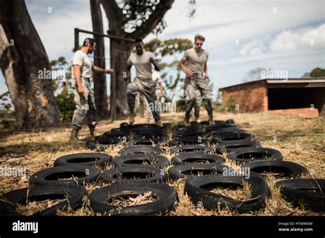 Trainer Giving Training To Military Soldiers At Boot Camp Stock Photo