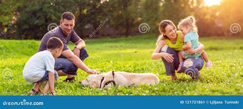 Happy Family is Having Fun with Golden Retriever - Family Playing with ...