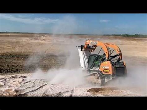 Spreading A Big Super Sack Of Bentonite Using A Skid Steer For Pond