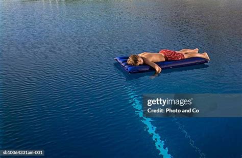 Barefoot Boy Lying On Stomach Photos And Premium High Res Pictures