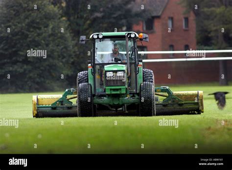 Tractor mower cutting grass Stock Photo - Alamy