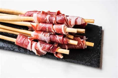 Premium Photo Grissini With Acorn Fed Iberian Ham On White Background