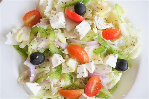 Premium Photo Close Up Of Greek Salad In A Bowl On Table