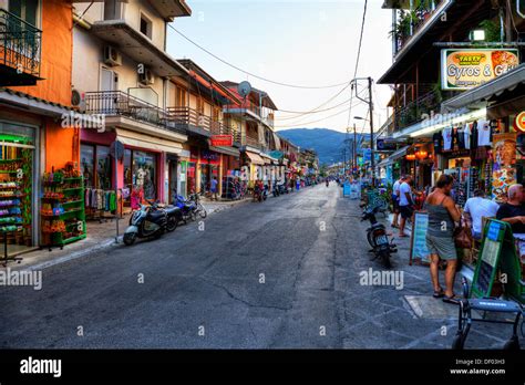 Dusk In Main Street Through Shops And Tavernas Nidri Nydri Lefkada