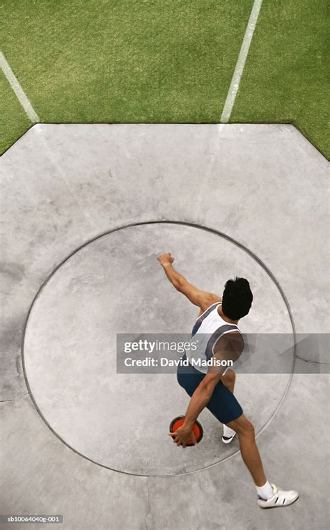 Man Preparing To Throw Discus At Track Elevated View High Res Stock