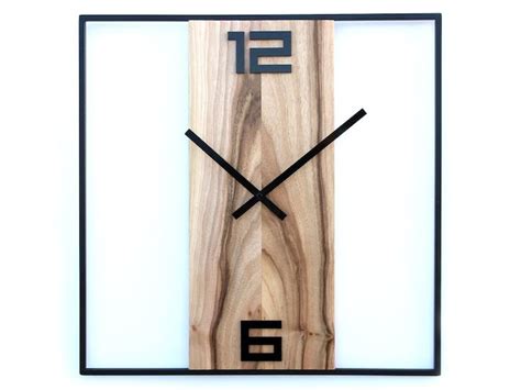 A Clock Made Out Of Wood With Black Numbers On The Front And Sides