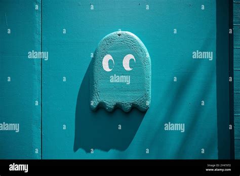 A Playful Depiction Of A Pac Man Ghost Is Painted In Vibrant Blue