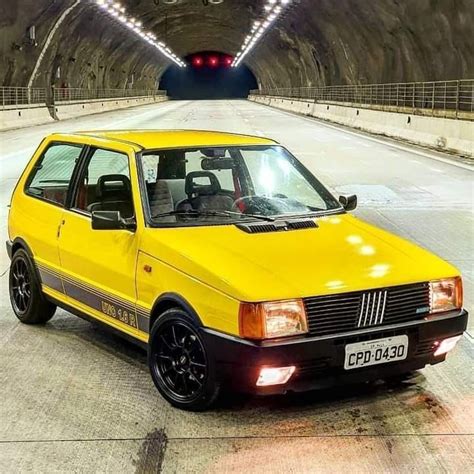 A Yellow Car Parked In Front Of A Tunnel