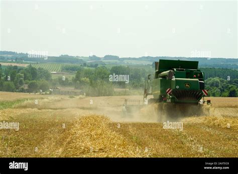 Harvesting Wheat Near Duras Lot Et Garonne France With A John Deere