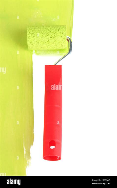 Roller brush with green paint closeup Stock Photo - Alamy