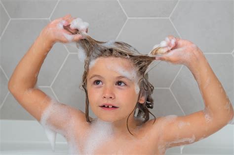 Kid laver les cheveux du savon sur la tête de l enfant face à l enfant