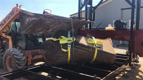 A Large Log Being Loaded Onto A Truck