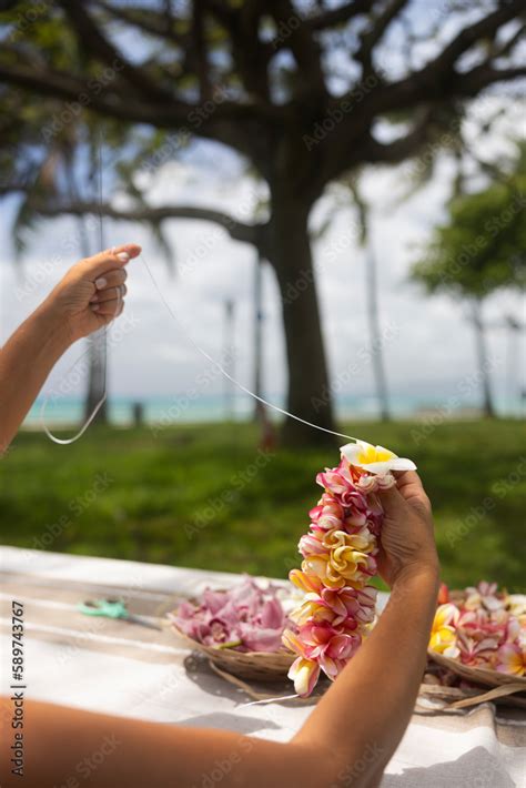 Woman making Hawaiian Lei and Hahu. Process of Handmade flower crown ...