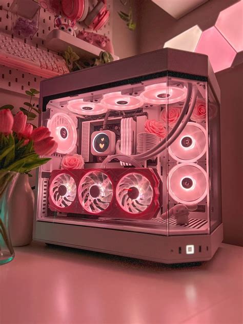 A Computer Case Sitting On Top Of A Table Next To A Vase Filled With