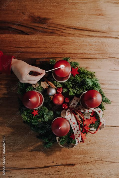 Child hand lighting the first candle of Advent Wreath on the first ...