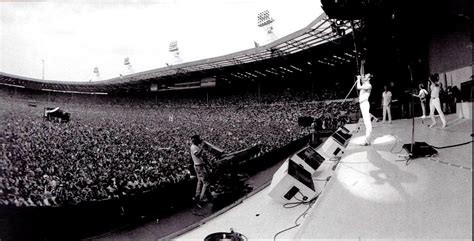 Queen Performing In Front Of People At The Live Aid Concert In