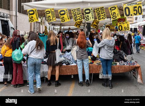 Young women browsing for affordable clothes at Mercato di Porta Portese ...