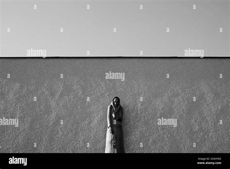 Statue Of Mourning Woman Widow In Front Of The Wall Minimalist