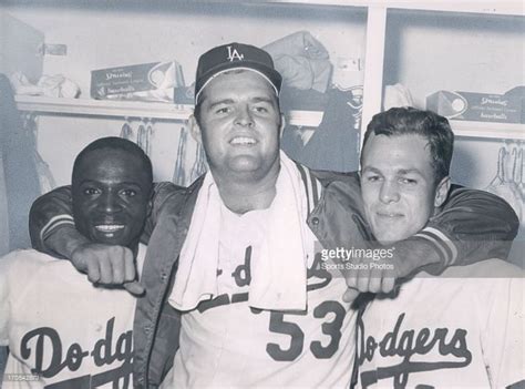 three baseball players posing for a photo in the dugout with one ...