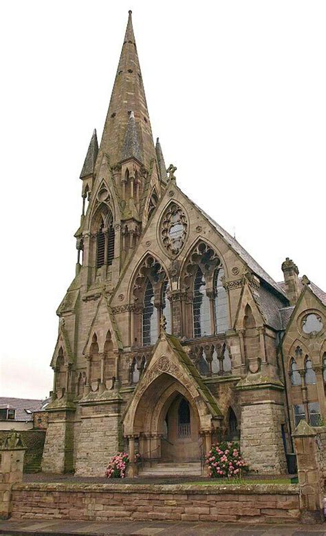 An Old Stone Church With A Clock Tower