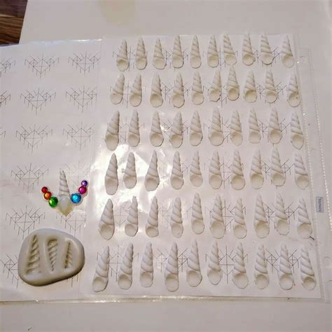 A Table Topped With Lots Of White Icing Next To A Cookie Sheet Covered