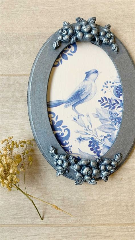 A Blue And White Plate Sitting On Top Of A Wooden Table Next To A Flower