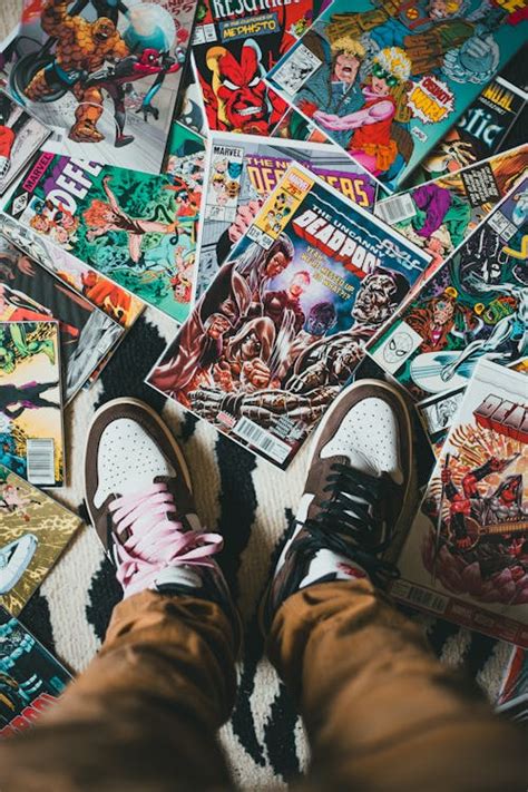 Person Standing On Pile Of Comics Books · Free Stock Photo