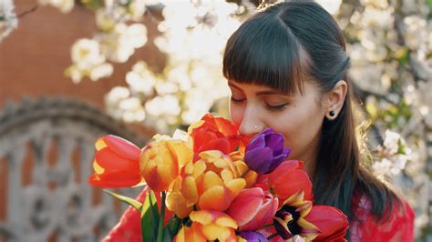 Woman Smelling Spring Flowers Stock Footage SBV-323468157 - Storyblocks