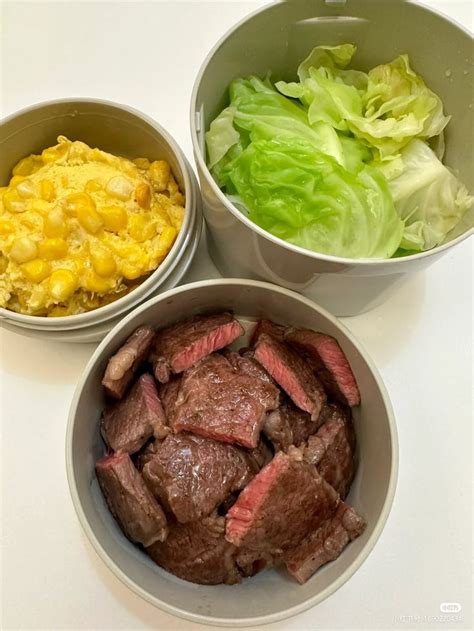 Three Bowls Filled With Meat And Vegetables On Top Of A White