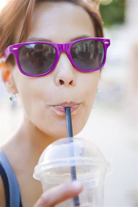 A Woman Quenches Her Thirst In The Street Stock Image Image Of Brunette Holding