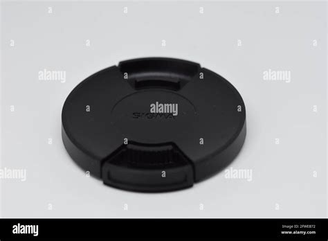 A Black Sigma Macro Lens Capcover With A Clean White Background Stock