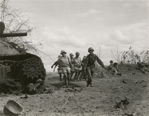 Filipino guerrillas help carry US wounded in the Philippines in 1945 ...