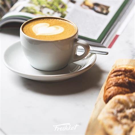 A Cup Of Coffee And Some Pastries On A Table