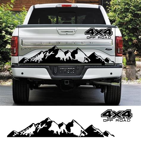 The Back End Of A Truck With Mountains On It