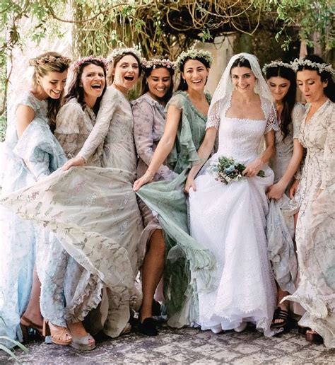 A Group Of Women Standing Next To Each Other Wearing Dresses And Veils